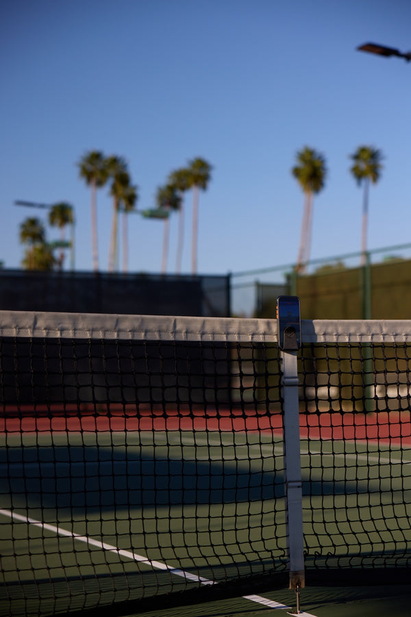Racquet View phone mount set up on a pickleball net
